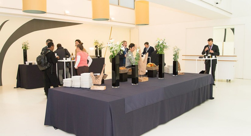 Coffee break in the white and bright VIP Room, with in the center a decorated table with catering